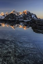 Sunrise, morning light, steep mountains by the sea, winter, Flakstadoya, Lofoten, Norway, Europe