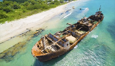 A dilapidated, rusty shipwreck in clear turquoise water on a sunny day, symbol photo, AI generated,