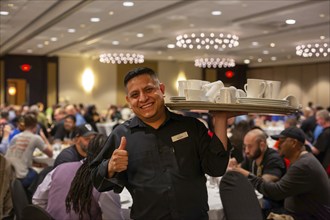 Chicago, Illinois - A worker clears dishes during a banquet at the Crowne Plaza Hotel.