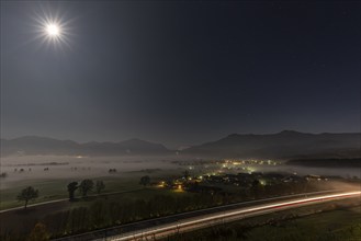 Night shot of a motorway, villages, full moon, fog, mountains, A 95, near Großweil, behind