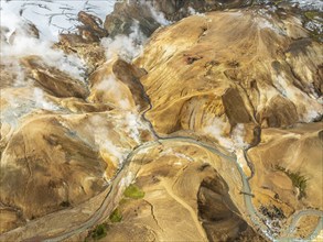 Steaming hot springs and colourful rhyolite mountains, aerial view, Hveradalir geothermal area,