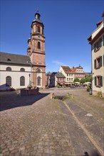 Old market square or Schnatterloch with St James' parish church and historic houses under a blue,