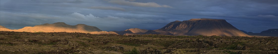 Large lava field and volcanic crater in the midnight sun, clouds, mood, panorama, Burfellshraun,