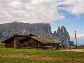 Alpine hut in front of the Sciliar, Punta Santner, Dolomites, Alpe di Siusi, South Tyrol, Italy,