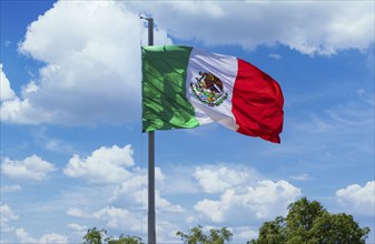 Los Cabos, Mexico, Mexican tricolor national striped flag proudly waving at mast in the air with