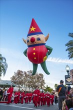 Elf helium balloon and its handlers in the Macy's Holiday Parade at Universal Studios, Orlando,