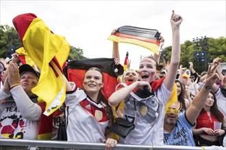 Celebrating football fans in the fan zone at the Brandenburg Tor during the quarter-final match