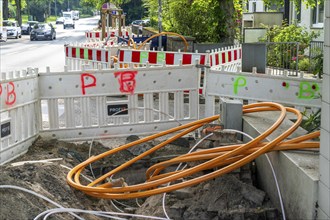 Laying of fibre optic cables, empty conduits are laid under a pavement, in which the actual fibre