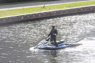 A police officer secures the Spree on a jet ski in front of the Federal Chancellery, 11 October