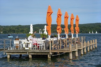 Old jetties with dining tables, lakeside restaurant, former Undosa wave pool, now H'ugo's Beach