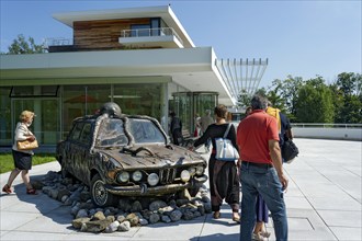 Visitors look at former BMW 250cs by Lothar-Günther Buchheim, car under water with octopus,