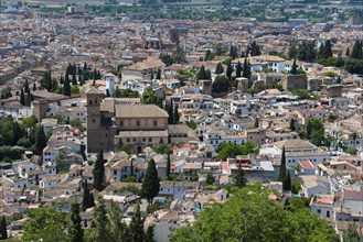 View over a historic town with brick houses, green vegetation and a peaceful Mediterranean