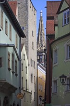 View through an old alley to the tower of St Peter's Cathedral, Regensburg, Upper Palatinate,