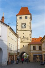 Historic tower with clock in a Bohemian old town, architectural landmark, Prague Tor, Melnik,