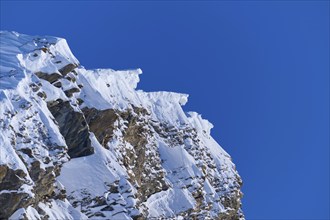 Snow-covered mountain peak with snow cornices under a clear blue sky, Gemmi Pass, Plattenhörner,