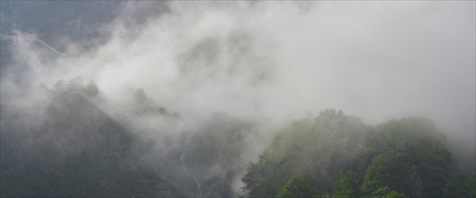 Clouds move over the mountains after a rain shower at Lago della Rovina, Entracque, province of