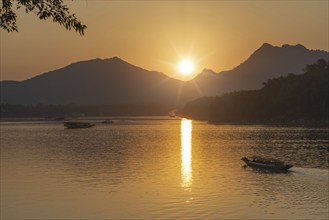 Sunset on the Mekong with excursion boats, near Luang Prabang, Laos, Asia