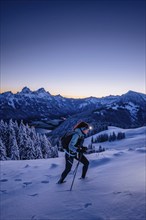 Hiking in the snow in the snow-covered winder landscape in the Alps at Neunerköpfle in the