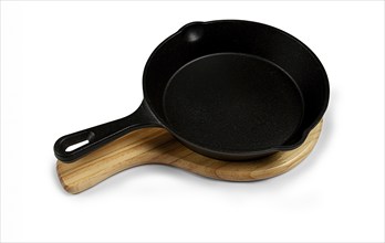 Portioned cast iron frying pan, on a wooden stand, new, on a white background, isolate