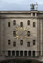 Large golden wall clock with twelve figures at the back of the Dynasty Palace, Brussels, Belgium,