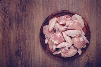 Raw chicken wings, on a wooden board, top view, no people