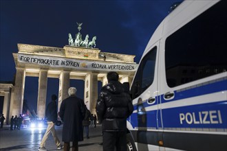 A banner For Democracy in Syria / Defend Rojava hangs at the Brandenburg Tor, Berlin, 16 December