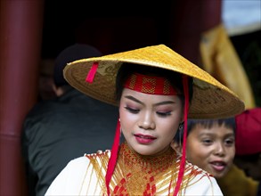 Toraja woman in traditional colourful clothing with rice straw hat, portrait, Tana Toraja,