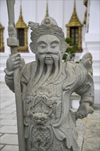 Stone statue of a Chinese warrior, guardian, Wat Phra Kaew, Temple of the Emerald Buddha, Bangkok,