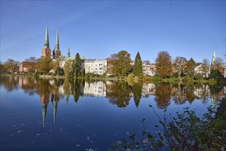 Mill pond with general buildings, Lübeck Cathedral and trees, symmetrical reflections on the water