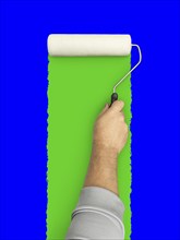 Male hand rolling paint roller over blue and green screen background