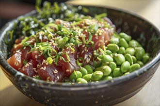 Poke bowl with marinated ahi tuna, edamame, seaweed salad, and a sprinkle of sesame seeds.