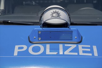 Police, patrol car, helmet lying on the bonnet, during a break, symbolic image