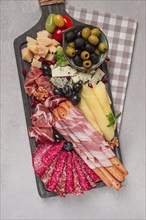 Appetizer, assortment, set, sausage, and cheese, on a wooden board, top view, no people