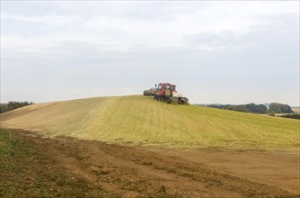 Piston Bully tracked bulldozer vehicle building silage clamp of sweetcorn maize in field stored for