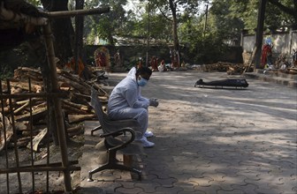 A family member mourns as a person died of COVID-19 coronavirus disease, at a cremation ground in