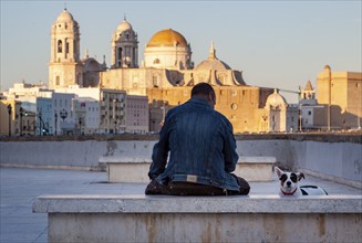 Man with dog in front of the cathedral of Cadiz, Andalusia, Spain, Europe