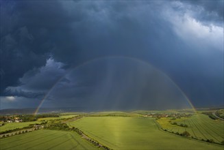 Thunderstorm cell with rainbow over fields near Krebs in the Osterzgebirge, Krebs, Saxony, Germany,