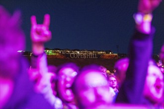 Copenhagen, Denmark - 19.6.2024: Festivalgoers with hands shaped like French fries in front of the