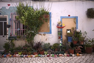 Plants, colourful painted stones, house facade, house, Portimão, Algarve, Portugal, Europe