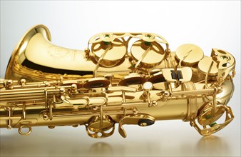 Saxophone in front of white background, detail, studio shot