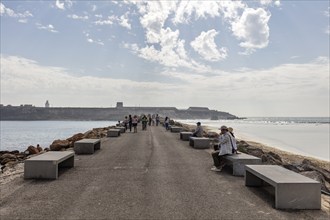 Promenade with benches and people enjoying the view of the sea, Tarifa