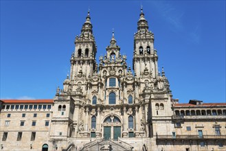 Impressive baroque cathedral with two towers and elaborate façade under a clear blue sky,