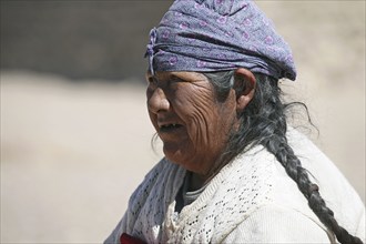 Portrait of traditionally dressed Bolivian woman with headscarf, Altiplano, Bolivia, South America