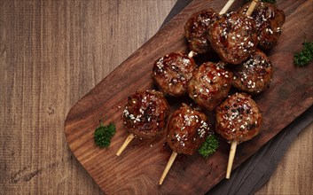 Tsukune, Japanese meatballs, minced chicken, fried on a skewer, with yakitori sauce, homemade, no