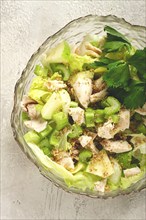 Waldorf salad, celery salad with apple, in a glass salad bowl, natural light, homemade, no people