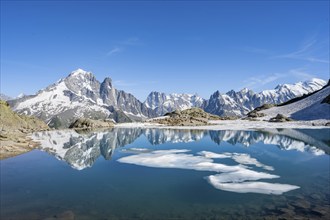 Mountain landscape with mountain lake and ice floe, water reflection in Lac Blanc, mountain peak,