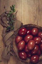 Painted eggs in a wooden bowl, red, painted madder dye, powder from the roots of endro, with onion