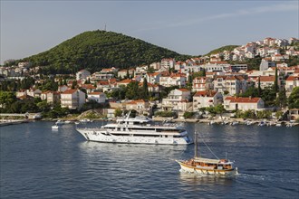 Suzana Zantium private yacht and sightseeing boat plus tan and white trim houses and villas with