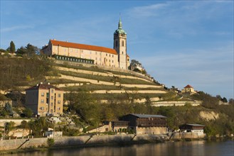 Historic church on a terraced hill with clear blue sky and surrounding nature, Melnik Castle,