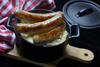 Nuremberg sausages with sauerkraut in a pot, Rostbratwurst, Germany, Europe